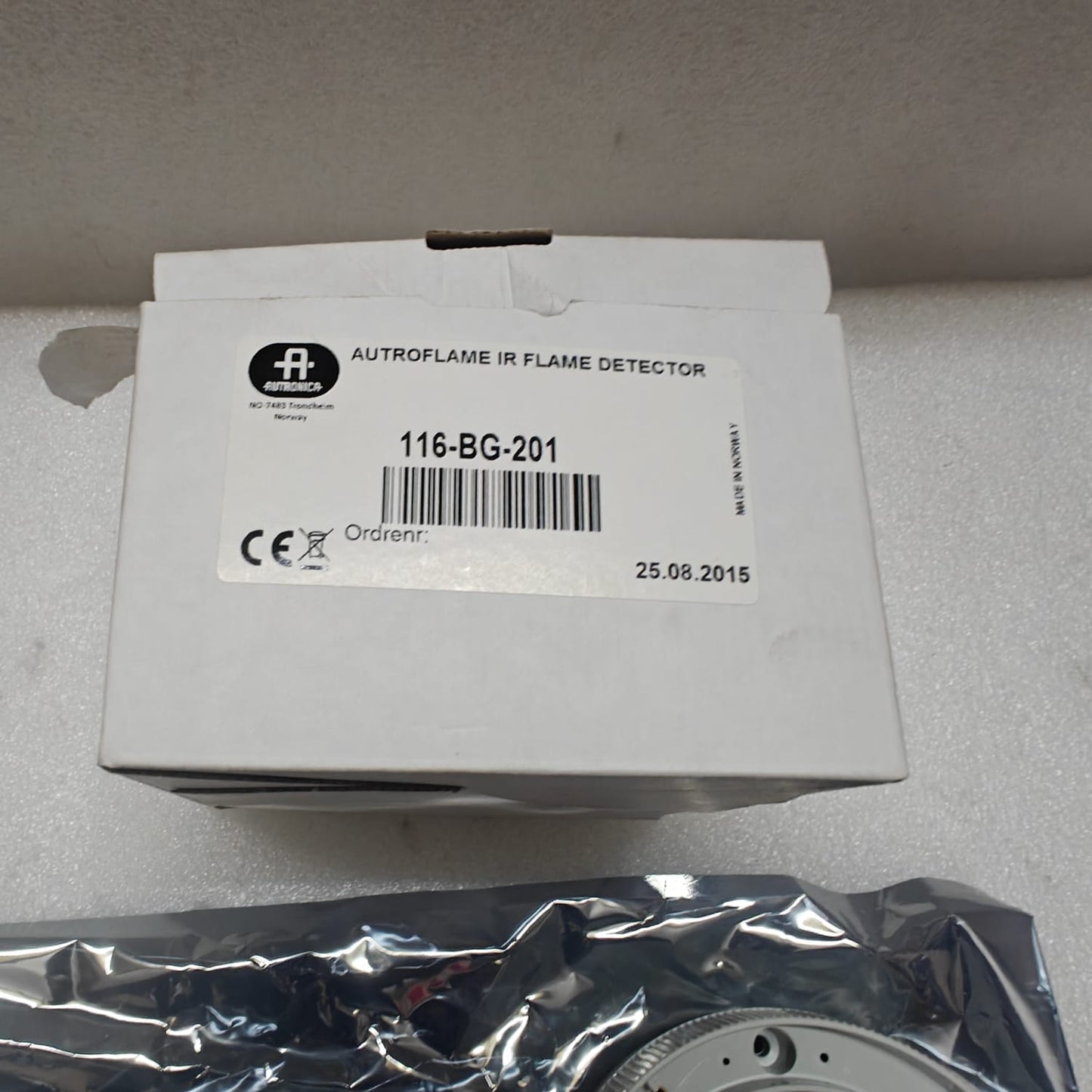 Autroflame IR flame detector packaging on a gray surface