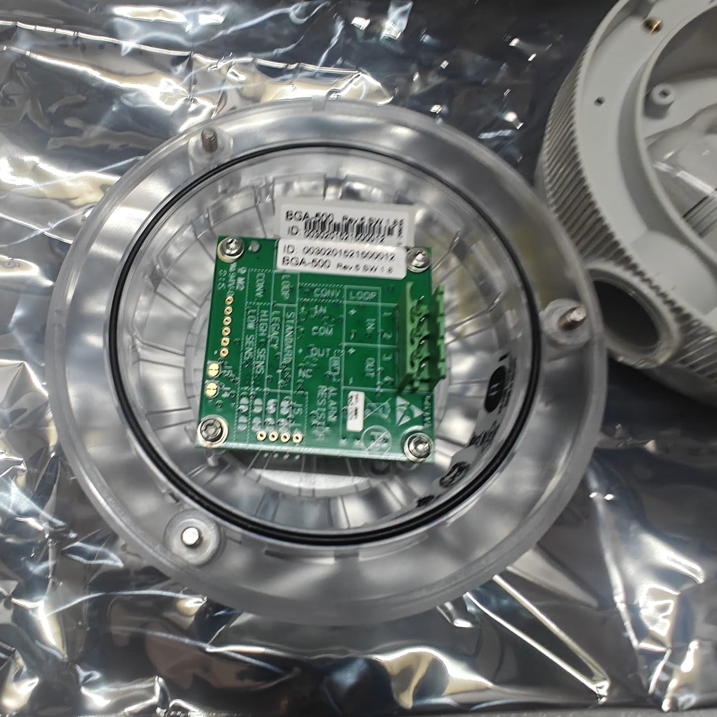 AUTRONICA 116-BG-201 AUTROFLAME IR FLAME DETECTOR with a green circuit board on a metallic casing, on a reflective surface.