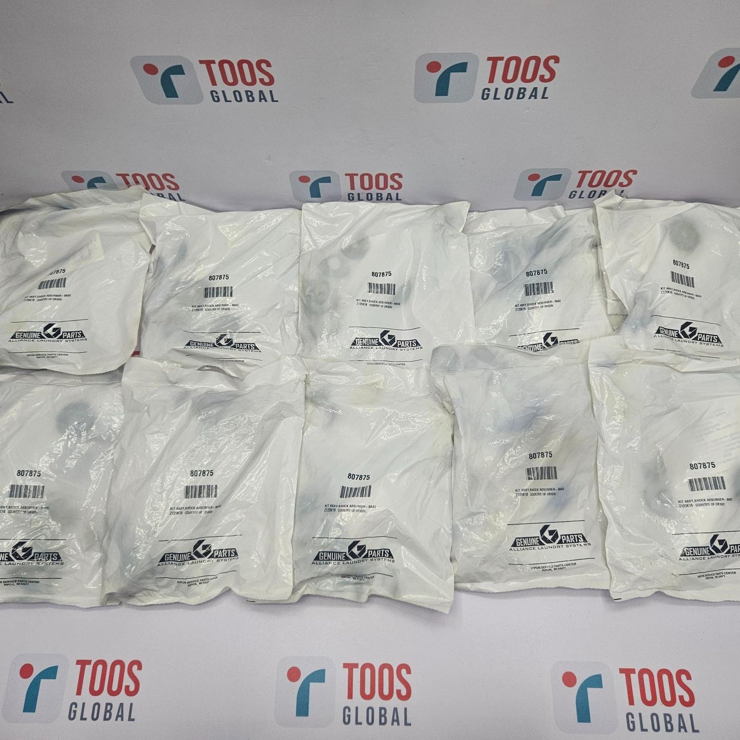 Multiple white packages with barcodes on a TOOS Global branded background