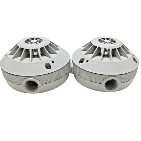 Two gray smoke detectors on a white background
