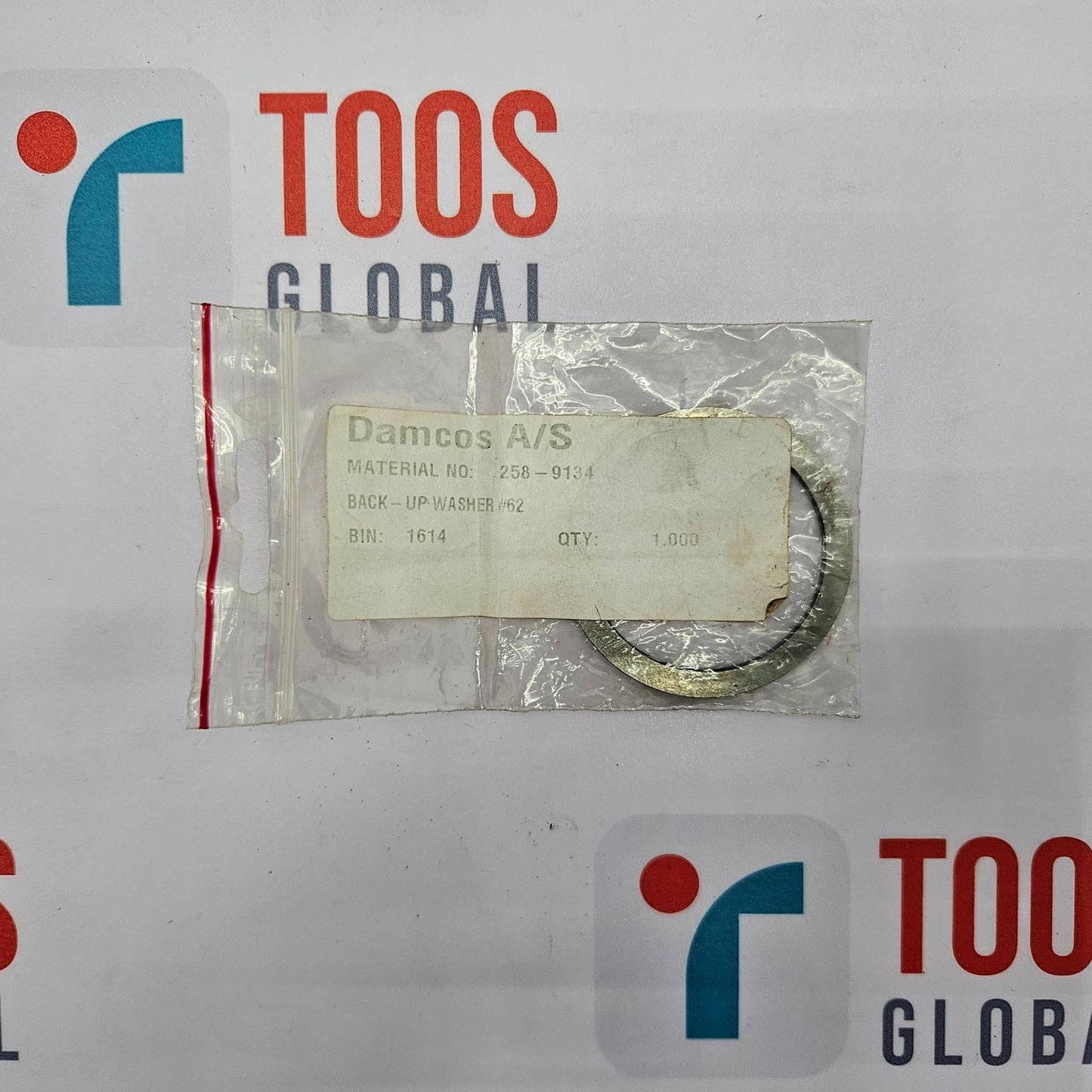 Packaged ring with a label on a TOOS GLOBAL branded background