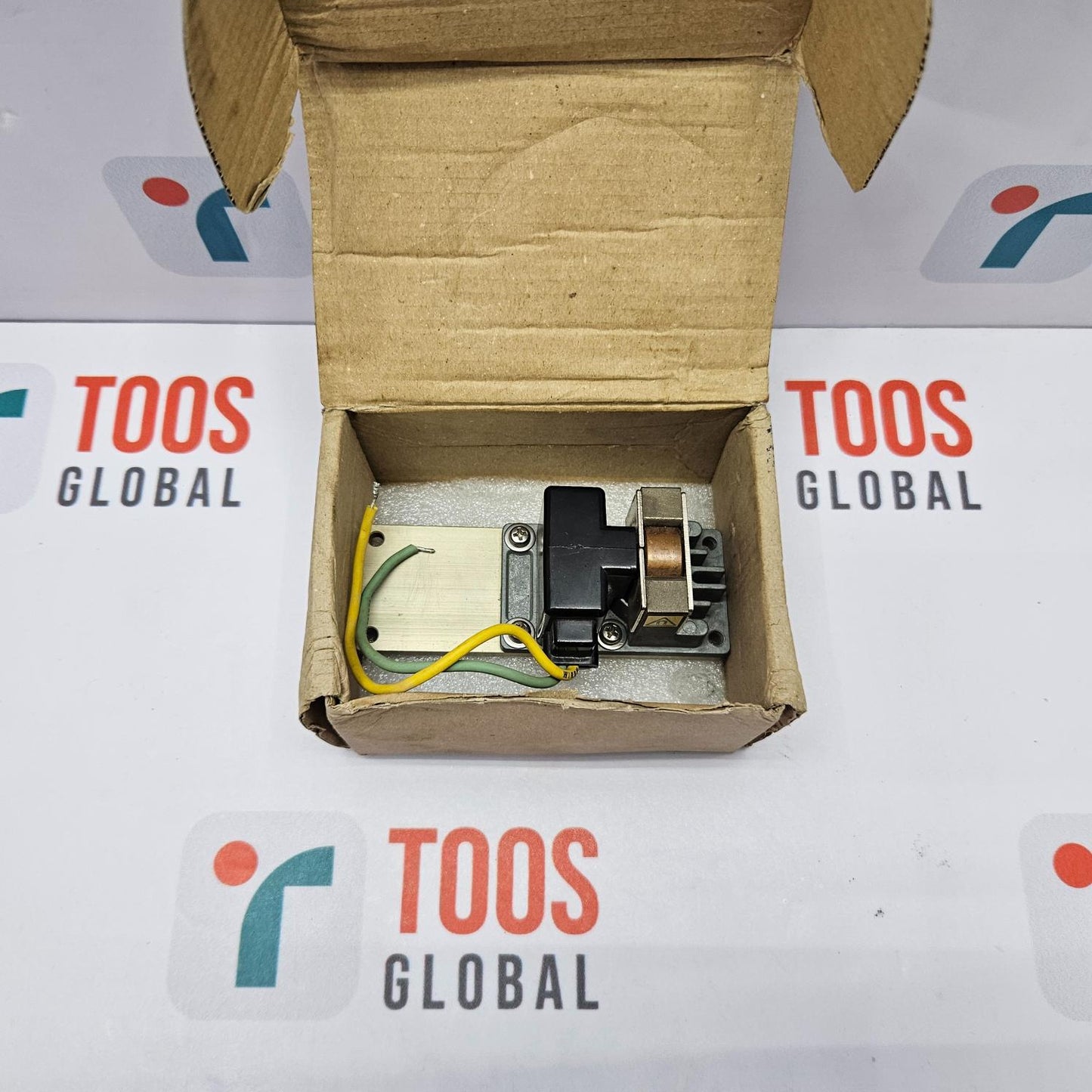 Open cardboard box with mechanical components inside, branded 'Tools Global' on a white background.