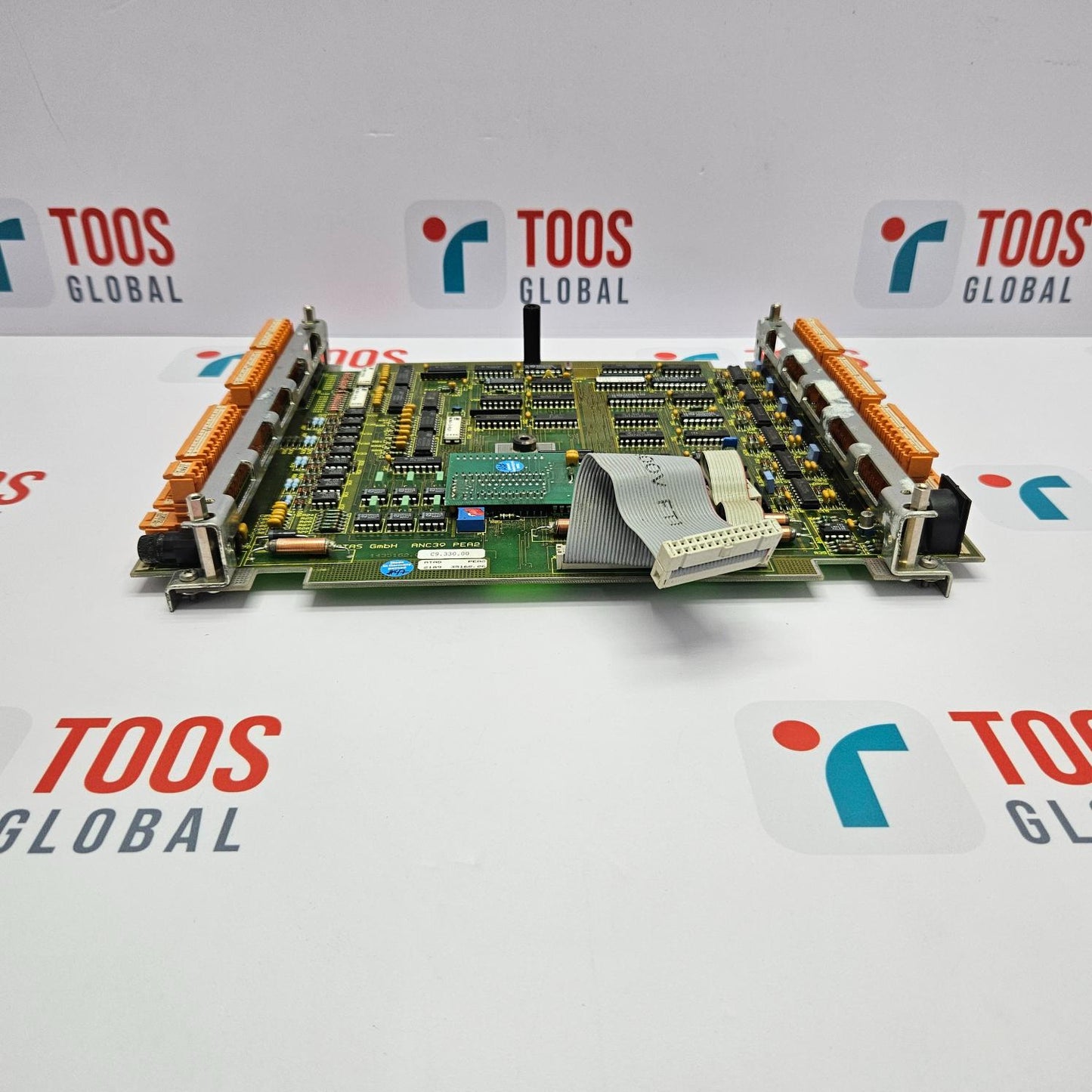 A printed circuit board (PCB) with various electronic components and connectors, laid out on a surface with the brand name 'ESAB' visible.