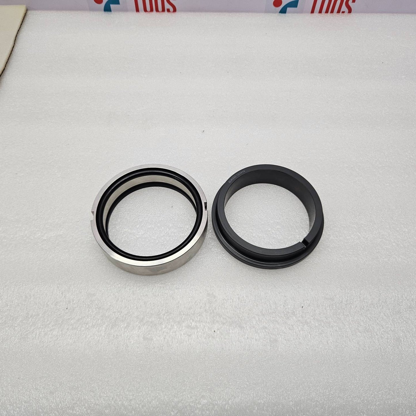 Two mechanical seals on a white background with visible brand logos.