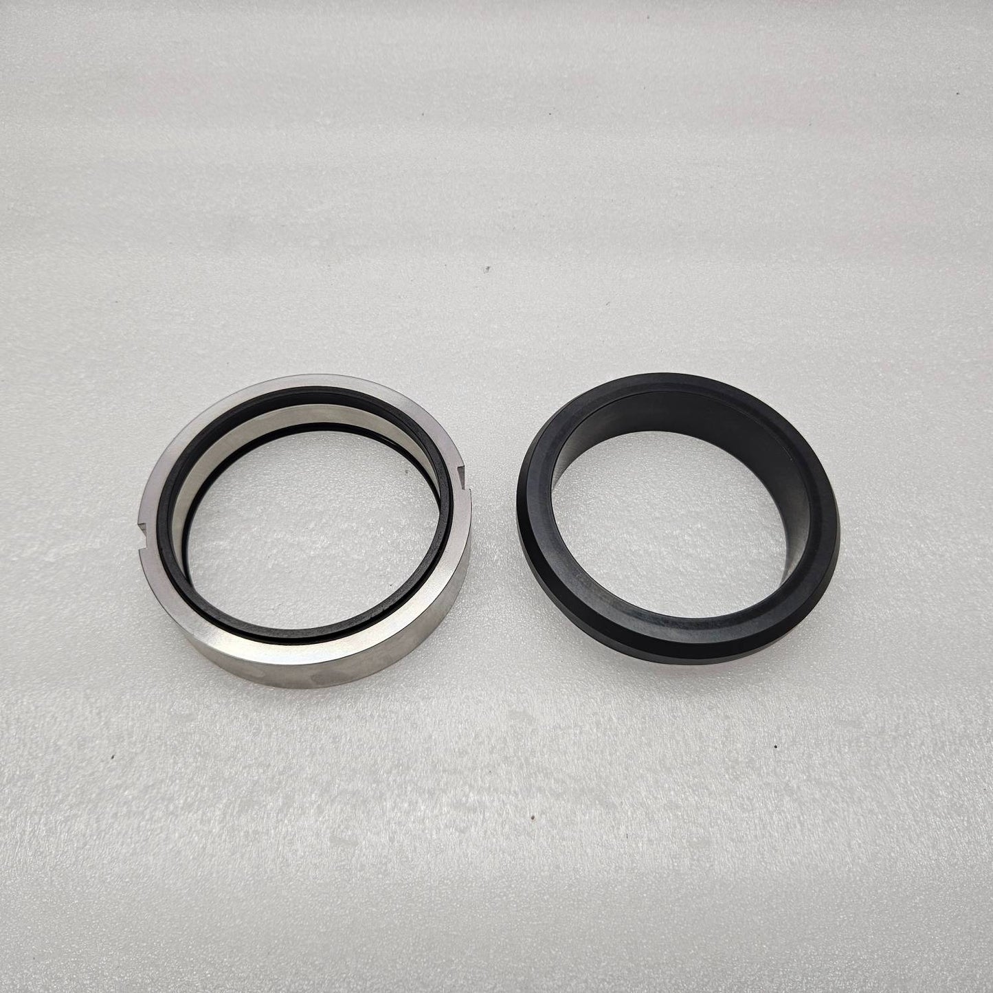 Two metal seals on a gray background