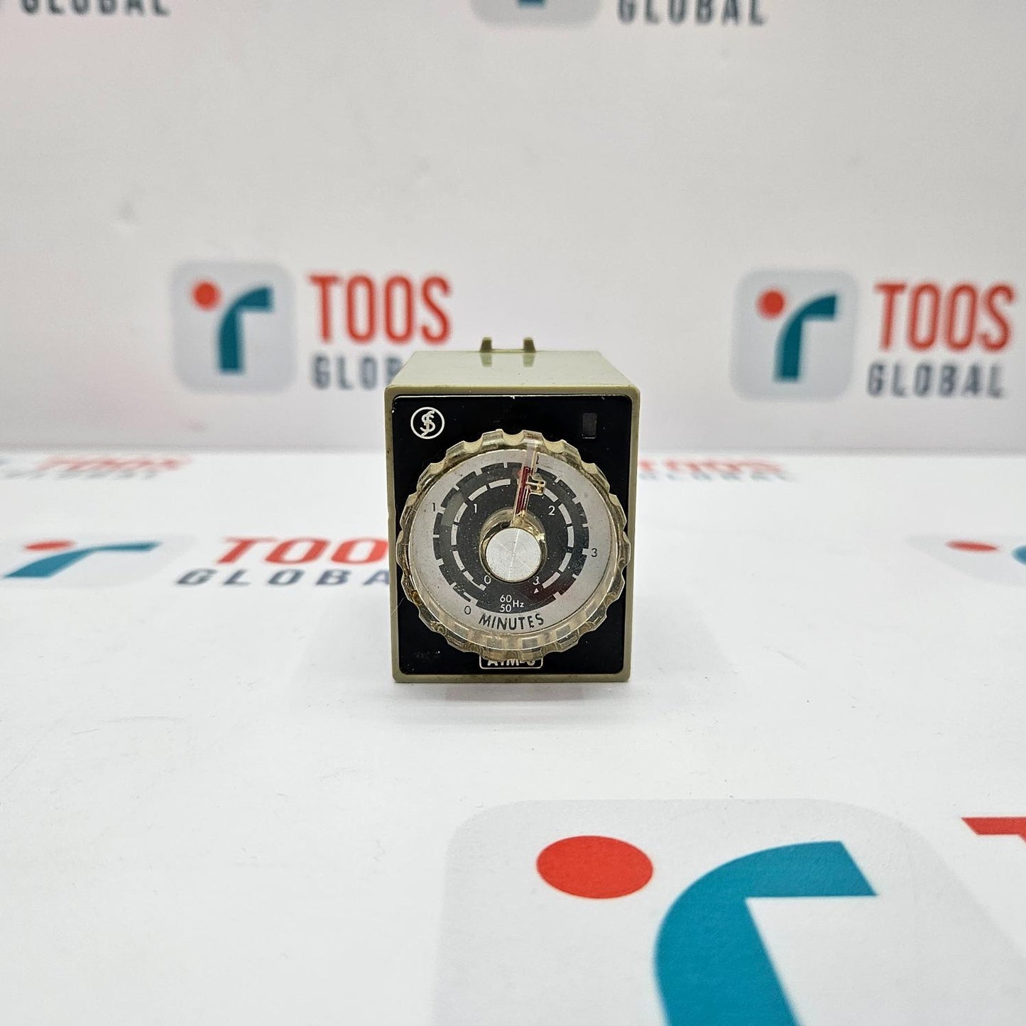 FUJI ELECTRIC ATM 3P MOTOR TIMER TIME RELAY FUJI ELECTRIC time relay with a black body and a dial, placed on a table with the TOOS GLOBAL logo.