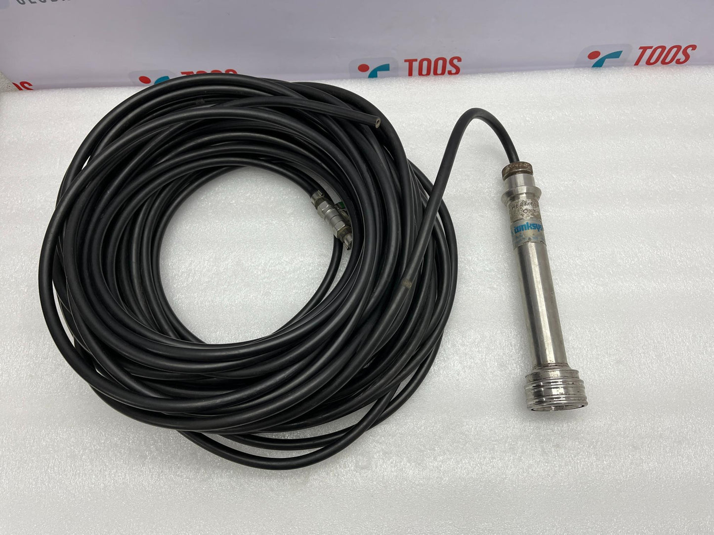 Probe with coiled cable on a white background with 'TOOS' branding.