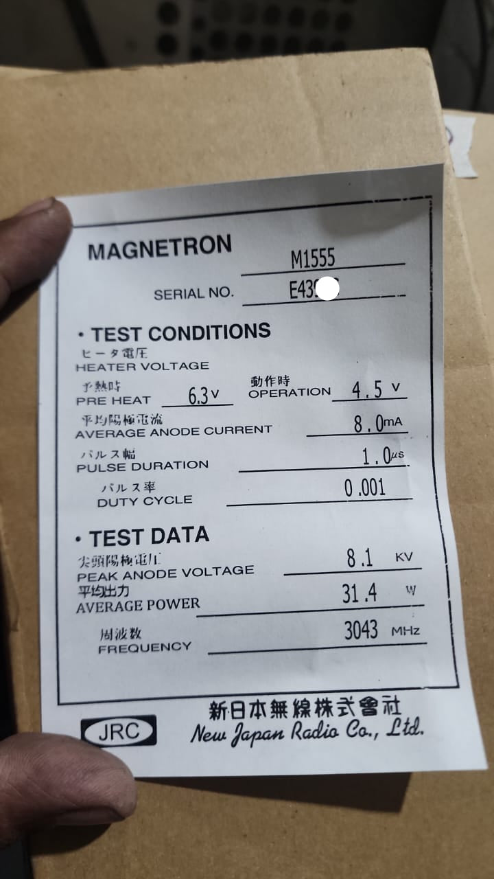 JRC M1555 Magnetron technical specifications label held by a hand on a cardboard box
