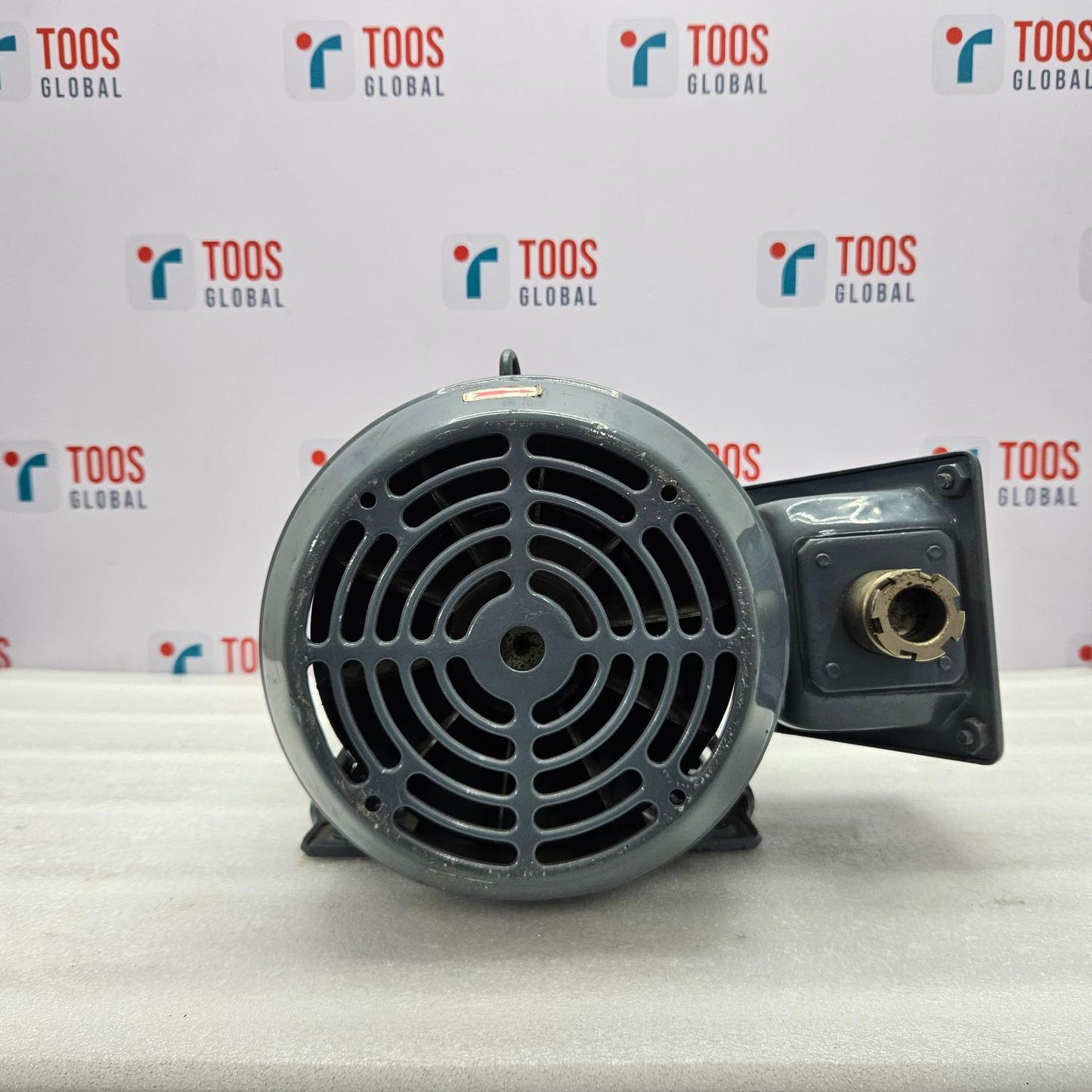 Motor on a white surface with 'TOOS GLOBAL' branding in the background