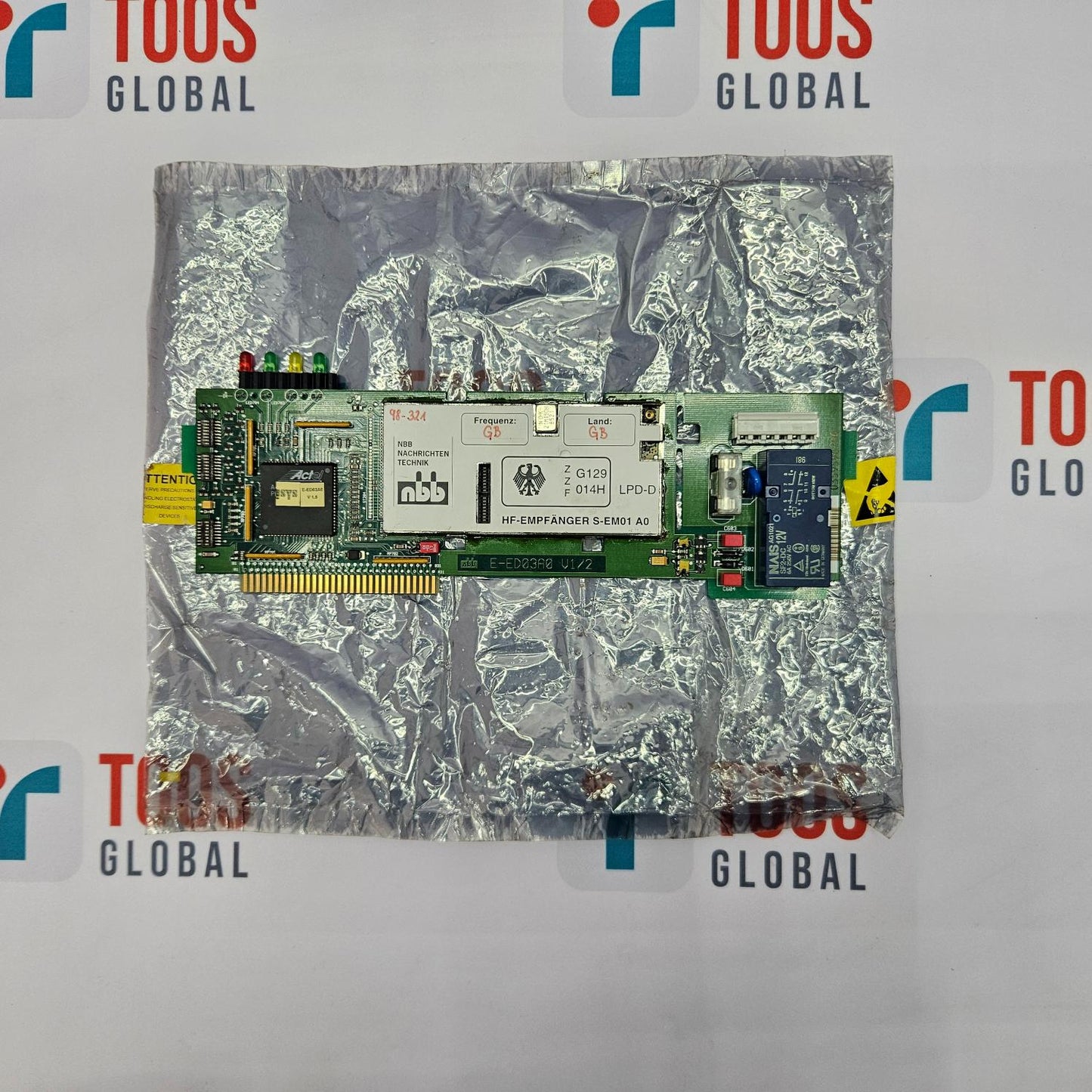 Computer memory module on a reflective surface with 'TOOS GLOBAL' branding.