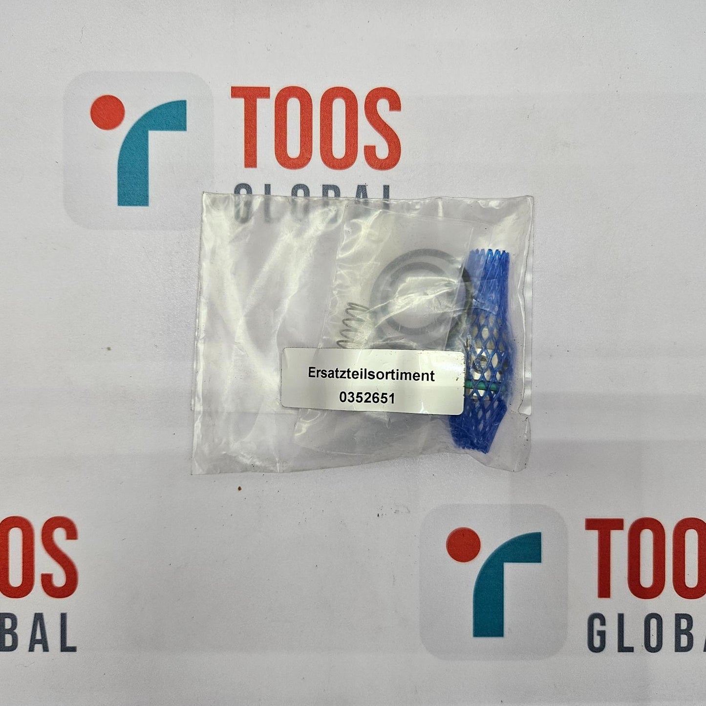 Packaged component with a label on a TOOS Global branded background