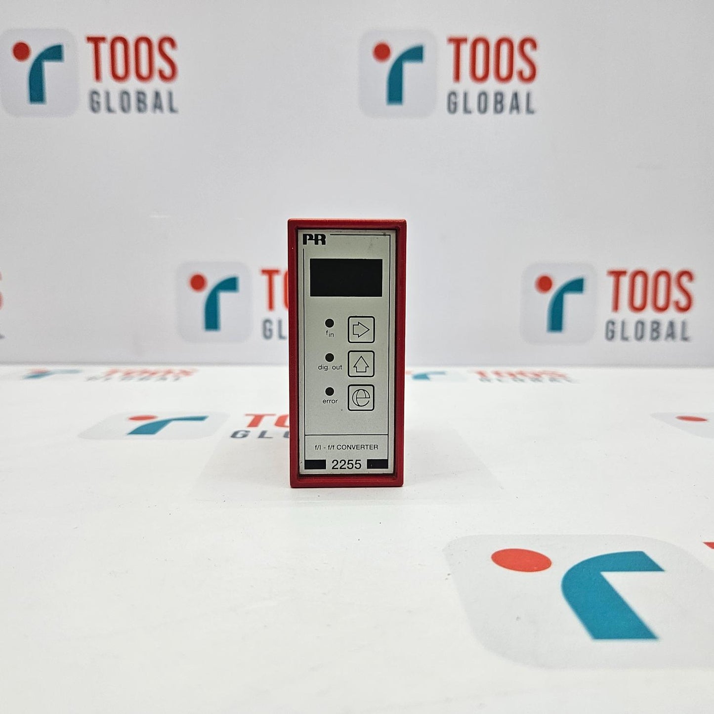 An industrial electronic device, PR ELECTRONICS 2255.1 F/I - F/F CONVERTER, with a digital display and several buttons, presented on a table with a logo in the background.