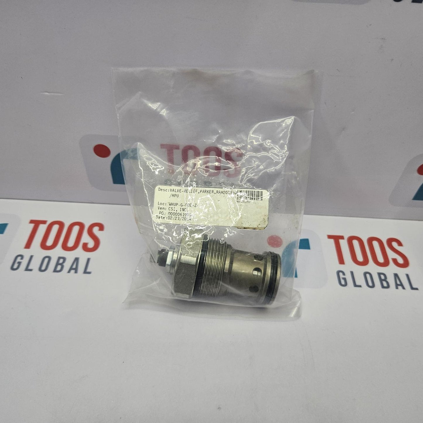 Mechanical component in a clear plastic bag on a TOOS GLOBAL branded background