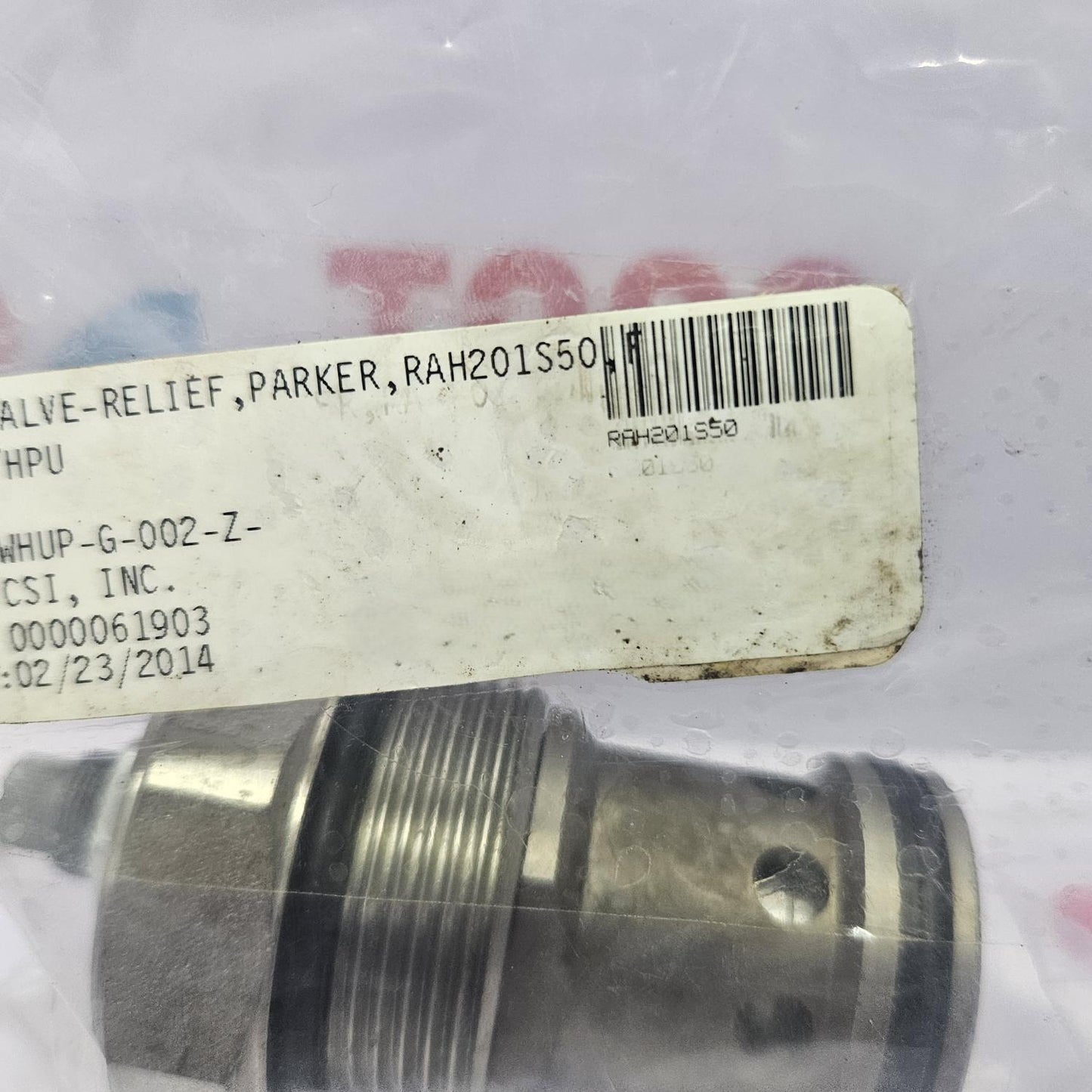 Metal valve component with a label on a white background