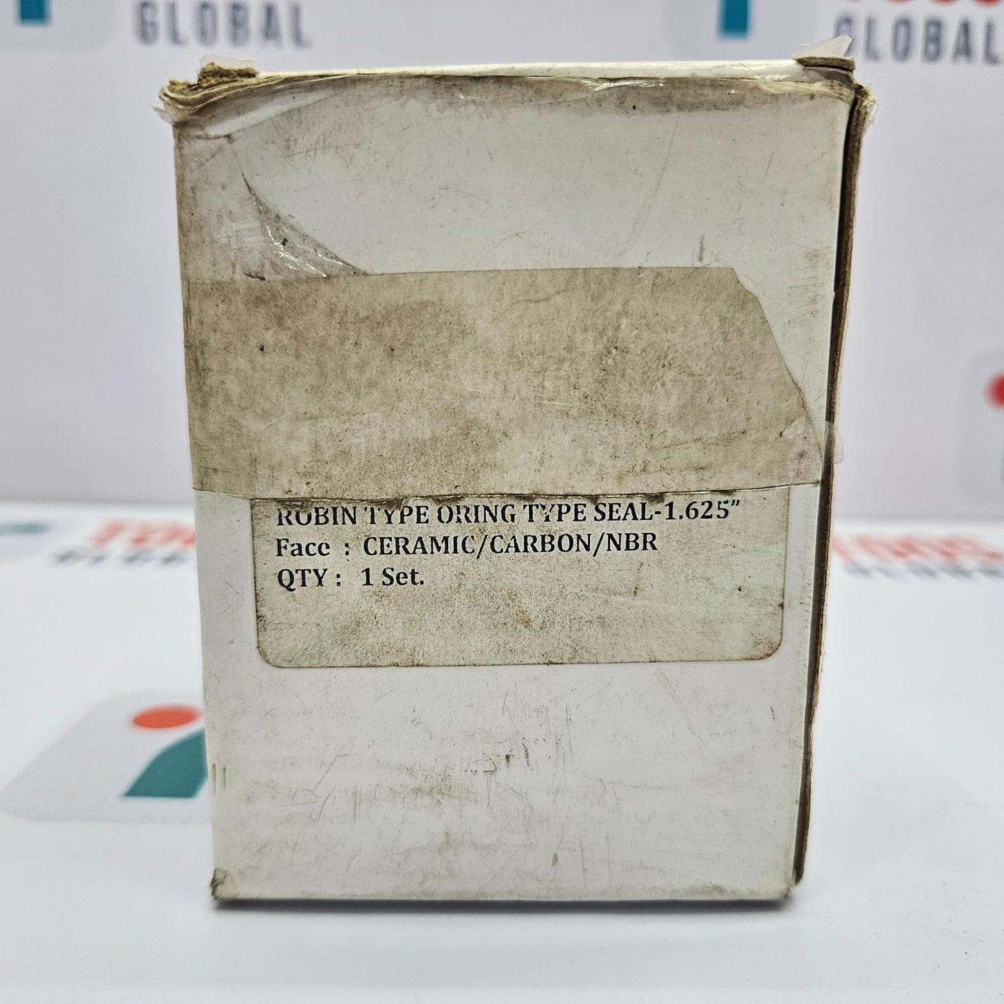 Worn-out box with technical specifications on a blurred background