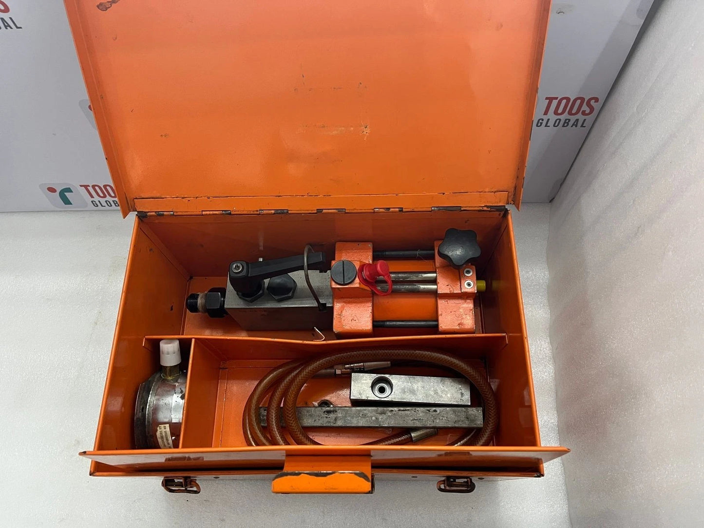 Orange tool box with tools inside on a white background