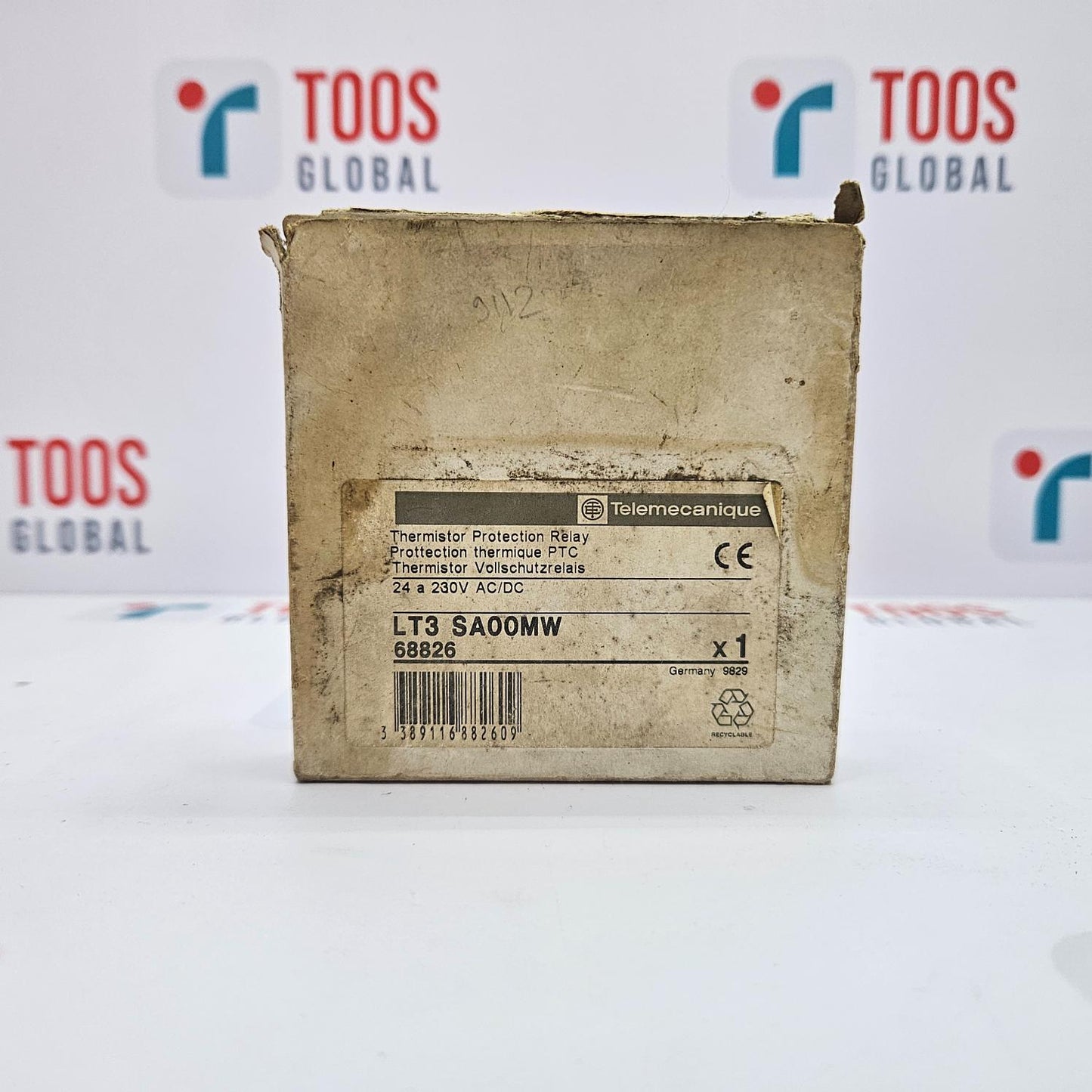 Worn-out box with a label on a white background featuring 'TOOS GLOBAL' branding.