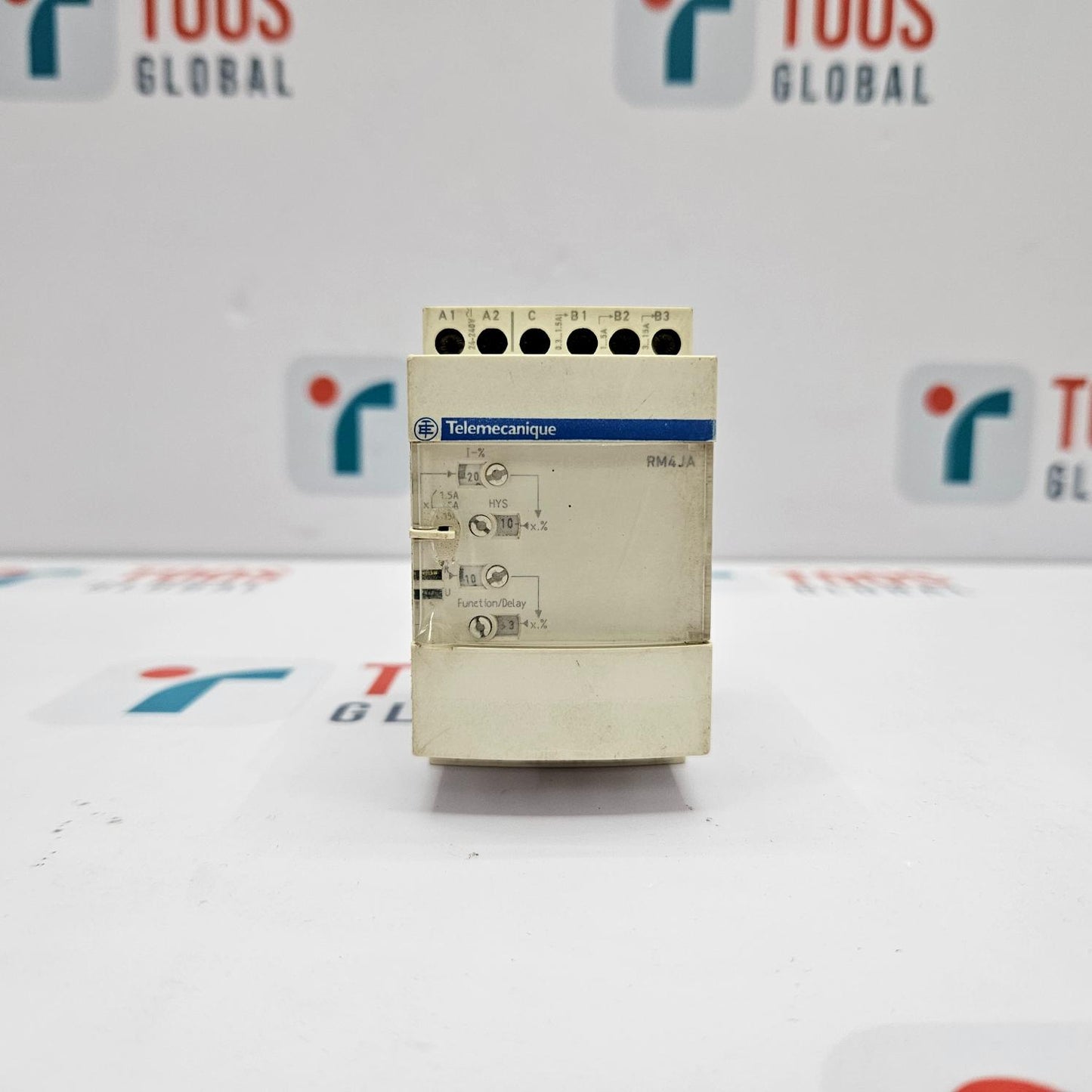 Control panel with Telemecanique branding on a white background with blurred logos.