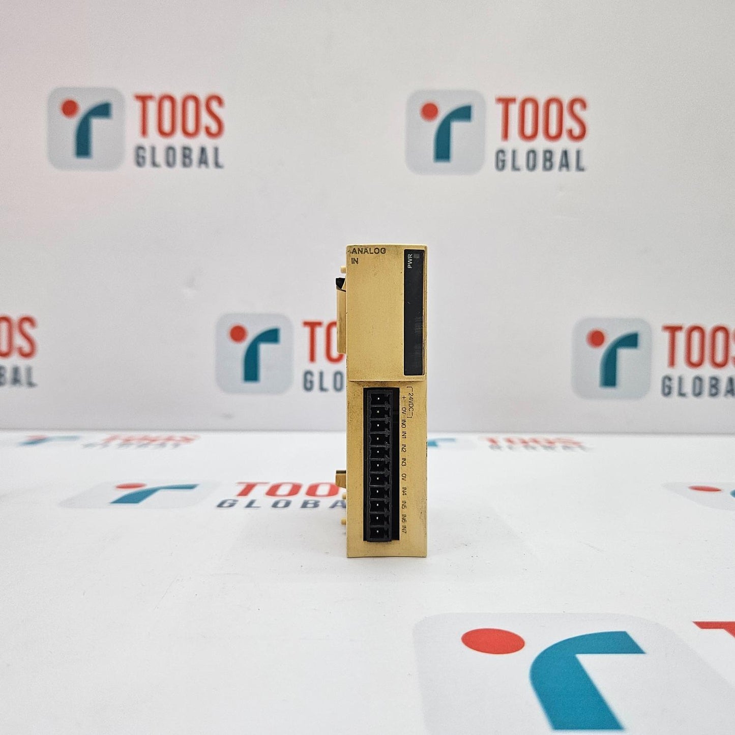 TELEMECANIQUE TWDAMI8HT TWIDO ANALOG INPUT MODULE Electronic module on a white surface with 'TOOS GLOBAL' branding in the background