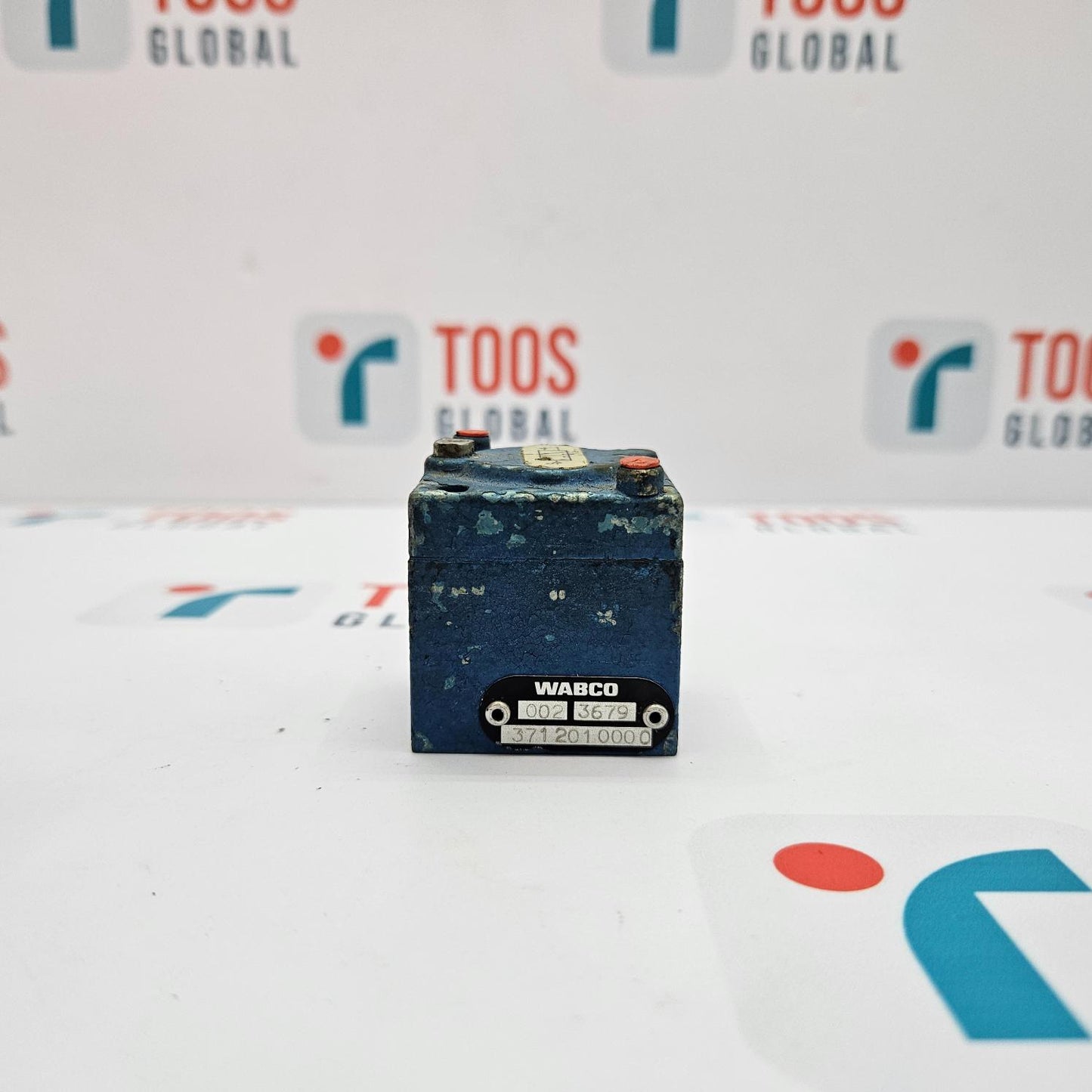WABCO battery on a white surface with 'TOOS GLOBAL' branding in the background