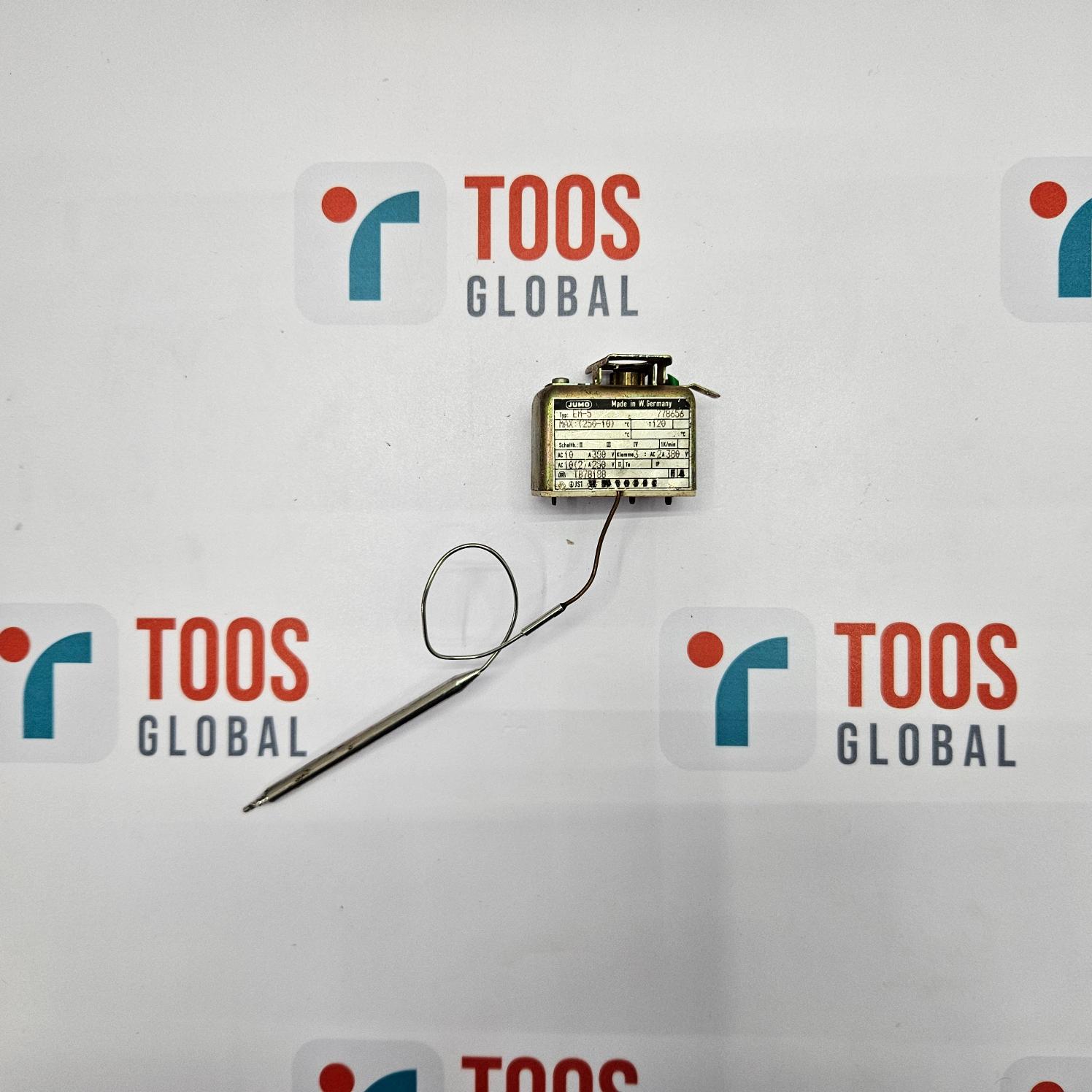 Small electronic device with a needle on a white background with 'TOOS GLOBAL' logos.