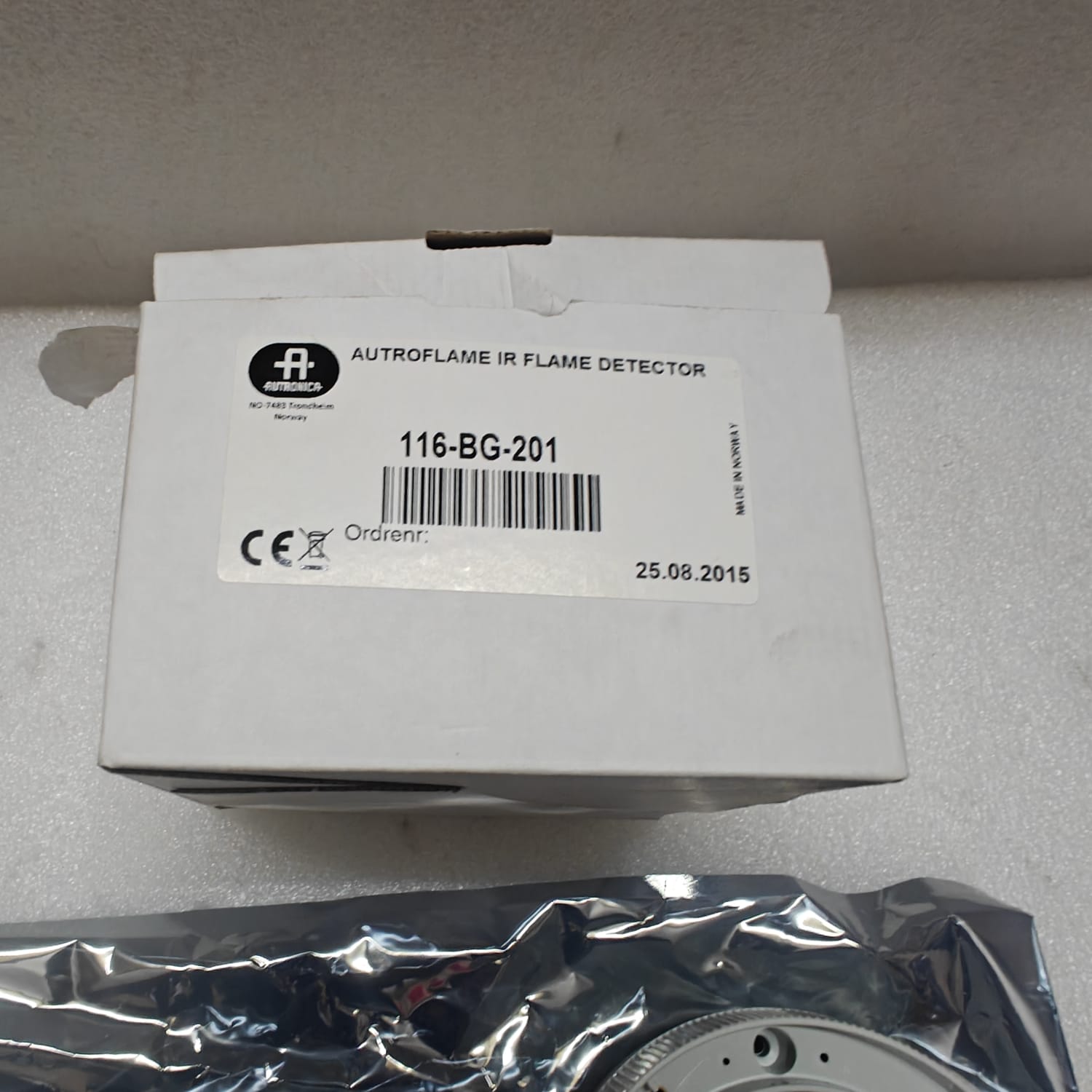 Autroflame IR flame detector packaging on a gray surface