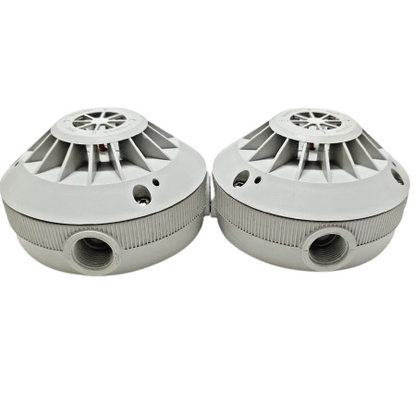 Two gray smoke detectors on a white background