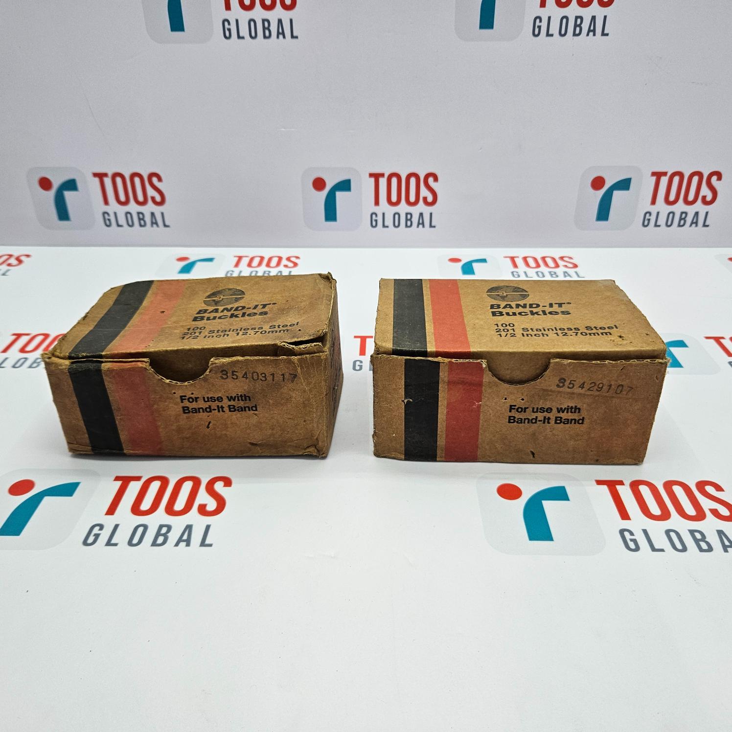 Two cardboard boxes with BAND-IT branding and model information, placed on a surface with the company's logo.