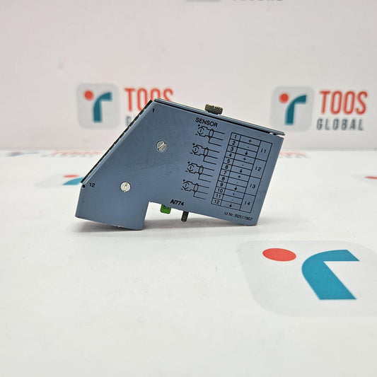 Electronic component on a white surface with 'TOOS' branding in the background