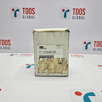Carrier Transicold Electric Valve Unloader 17-10349-00 Kit N The image shows a Carrier Transicold electric valve unloader kit in its original packaging, which is a cardboard box with visible signs of wear and marking, placed on a table with the brand name 'TOOS GLOBAL' visible in the background.