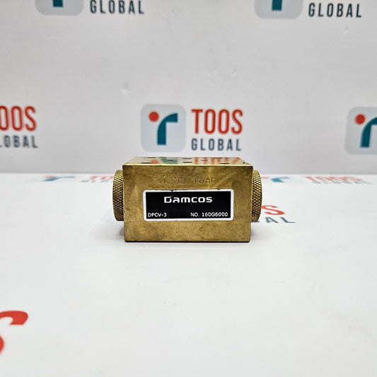 Gold-colored mechanical component with 'DAMCOS' branding on a white background with 'TOOS GLOBAL' logos.