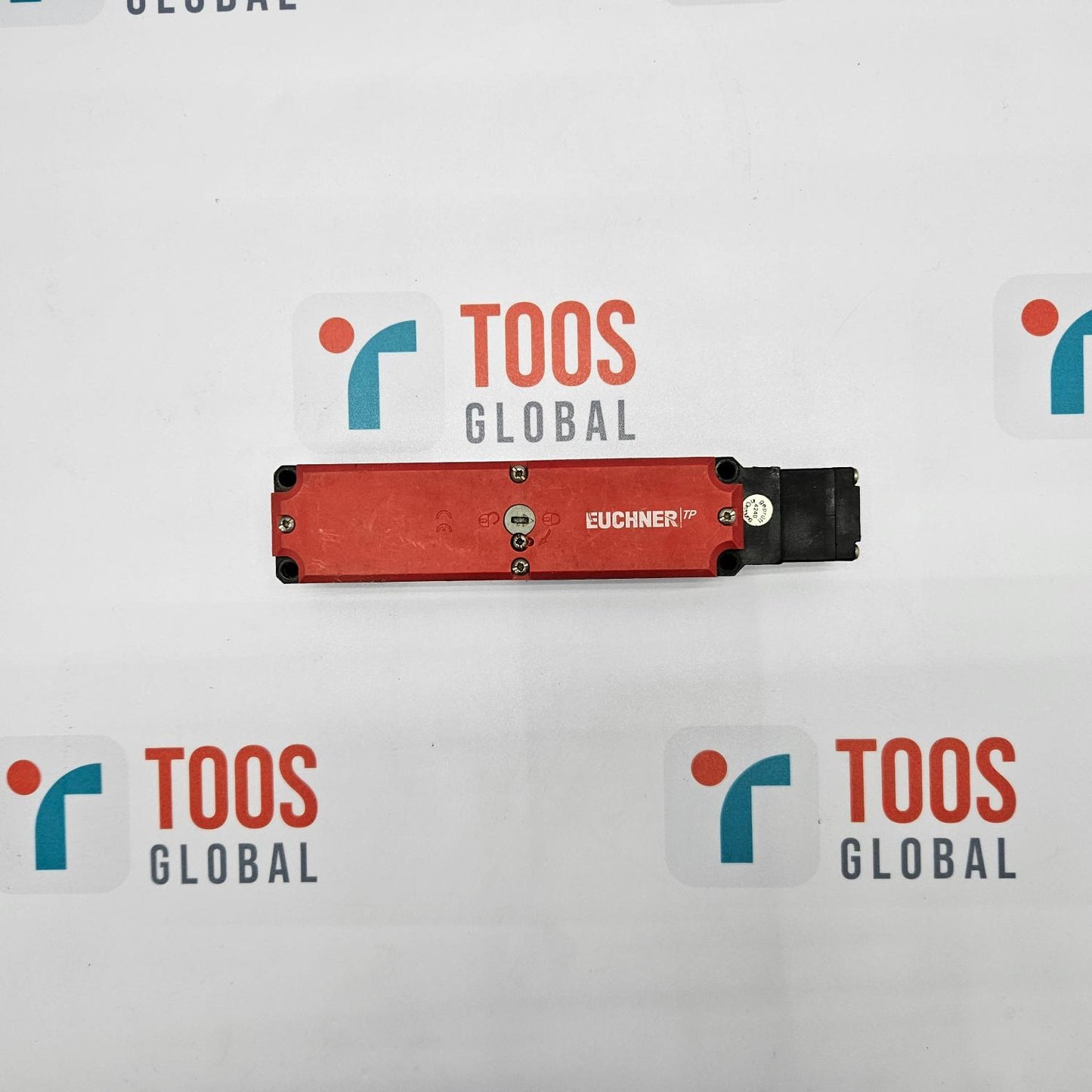 EUCHNER TP4-4141A024M SAFETY SWITCH EUCHNER safety switch, with a red actuation lever, mounted on a white surface with multiple TOOS GLOBAL logos.