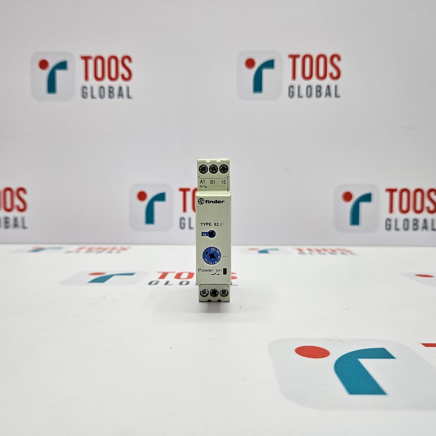 Small electronic device on a white surface with 'TOOS GLOBAL' branding in the background.