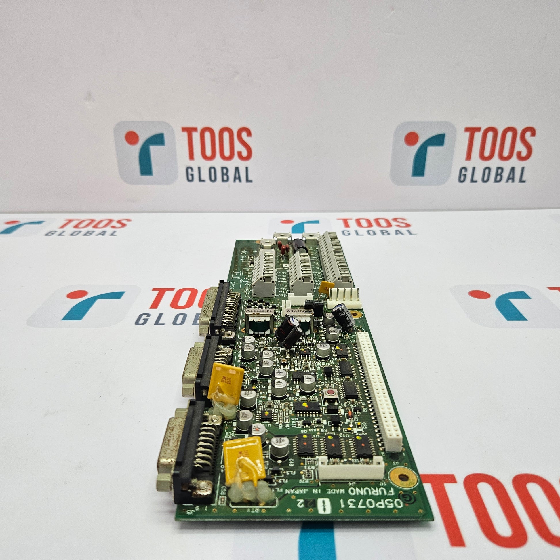 Electronic circuit board on a white background with 'TOOS GLOBAL' branding.