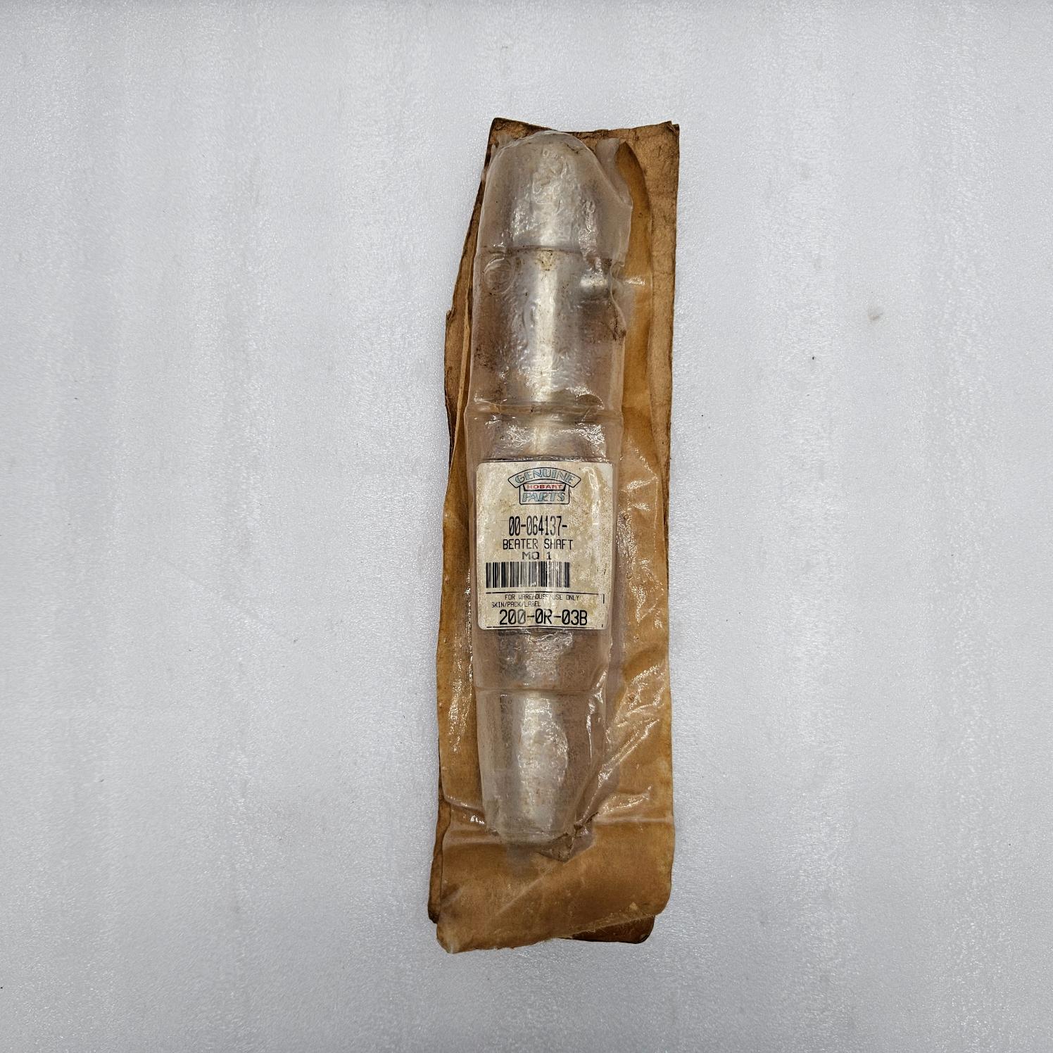 Metallic object in a brown paper package on a gray background