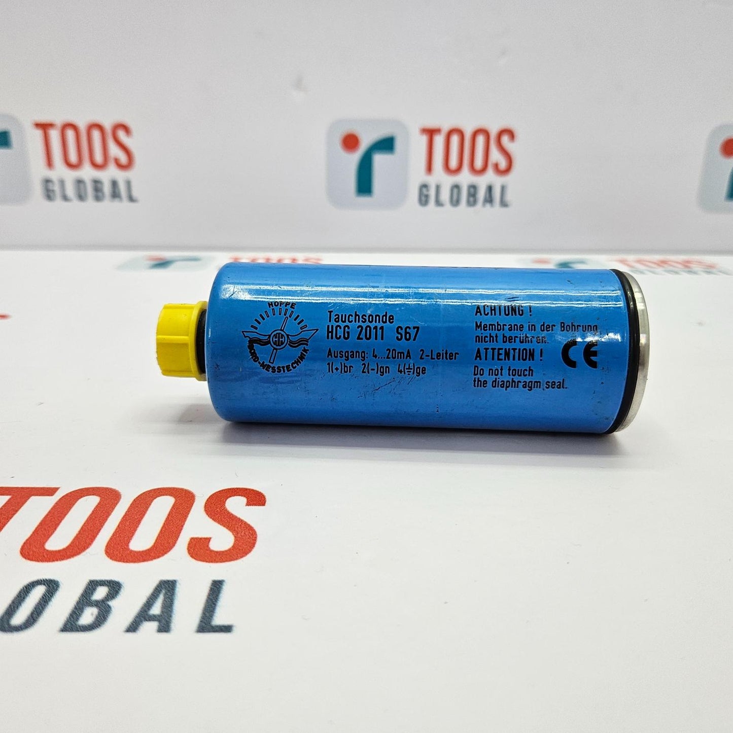 Blue cylindrical device with yellow end cap on a white background with 'TOOS GLOBAL' branding.