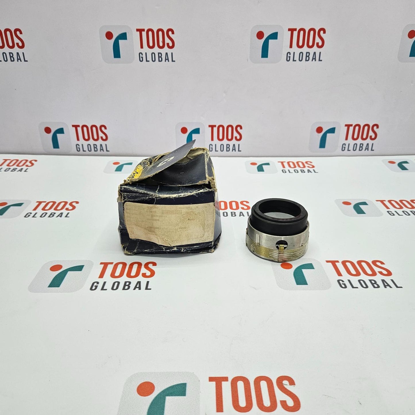 Mechanical parts on a white surface with 'TOOS GLOBAL' branding.