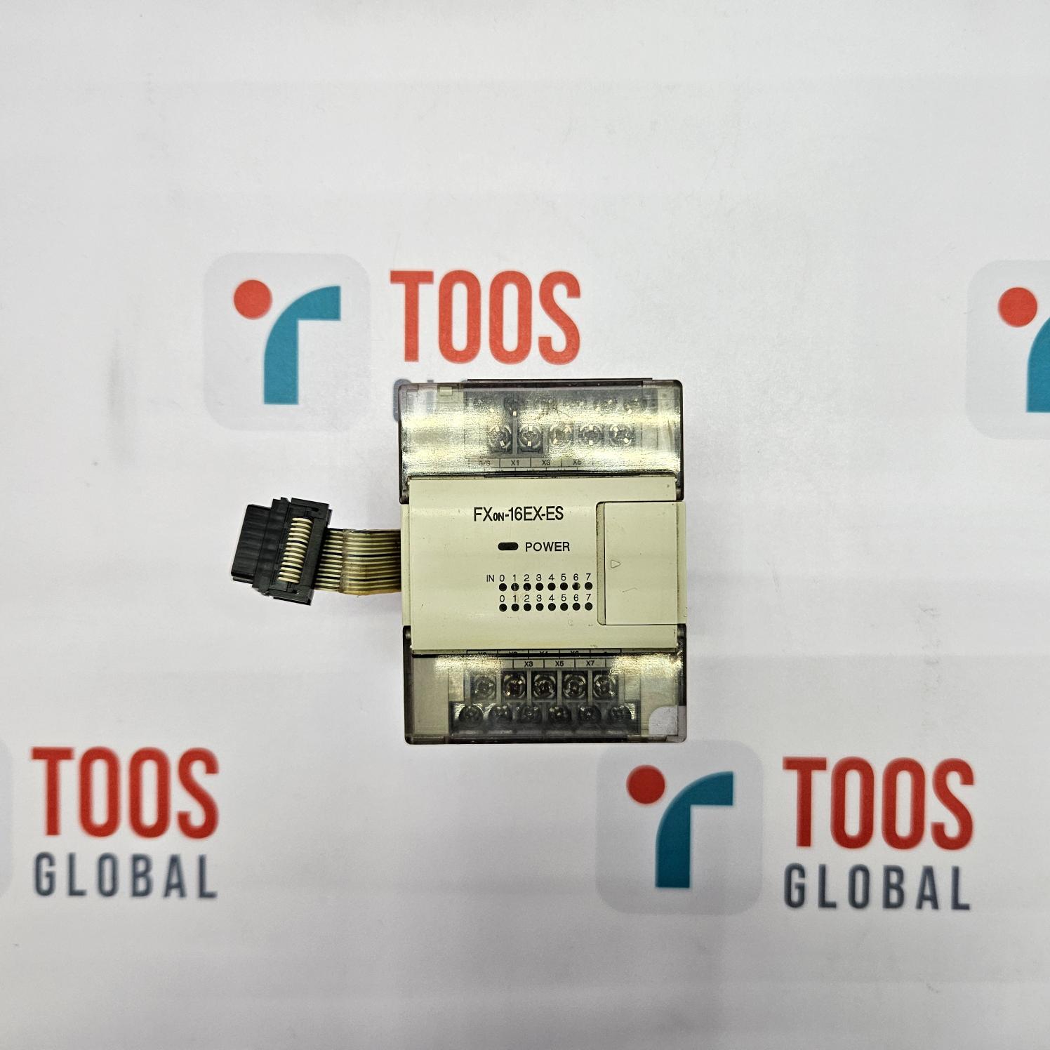 Electronic module with 'TOOS' branding on a white background
