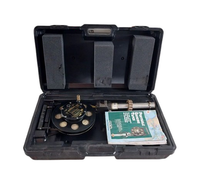 Open black tool case with MMC UTI TAPE MODEL: D-2401-2 UTI TAPE and a manual on a white background