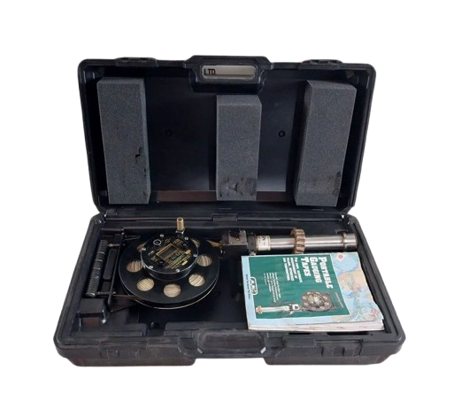 Open black tool case with MMC UTI TAPE MODEL: D-2401-2 UTI TAPE and a manual on a white background