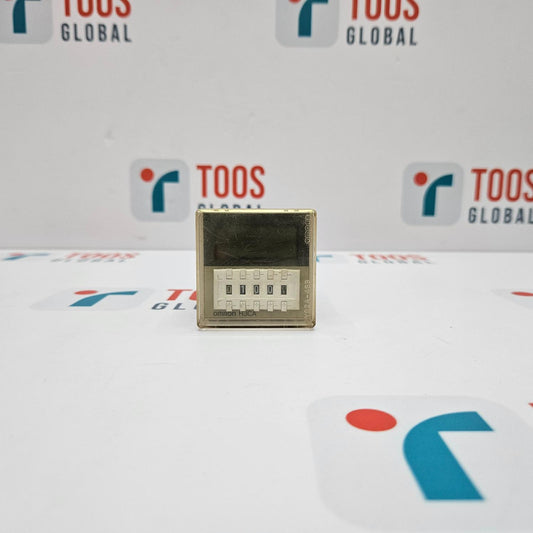 Small electronic component on a white surface with 'TOOS GLOBAL' branding in the background.
