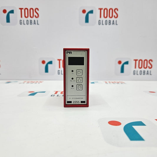 An industrial electronic device, PR ELECTRONICS 2255.1 F/I - F/F CONVERTER, with a digital display and several buttons, presented on a table with a logo in the background.