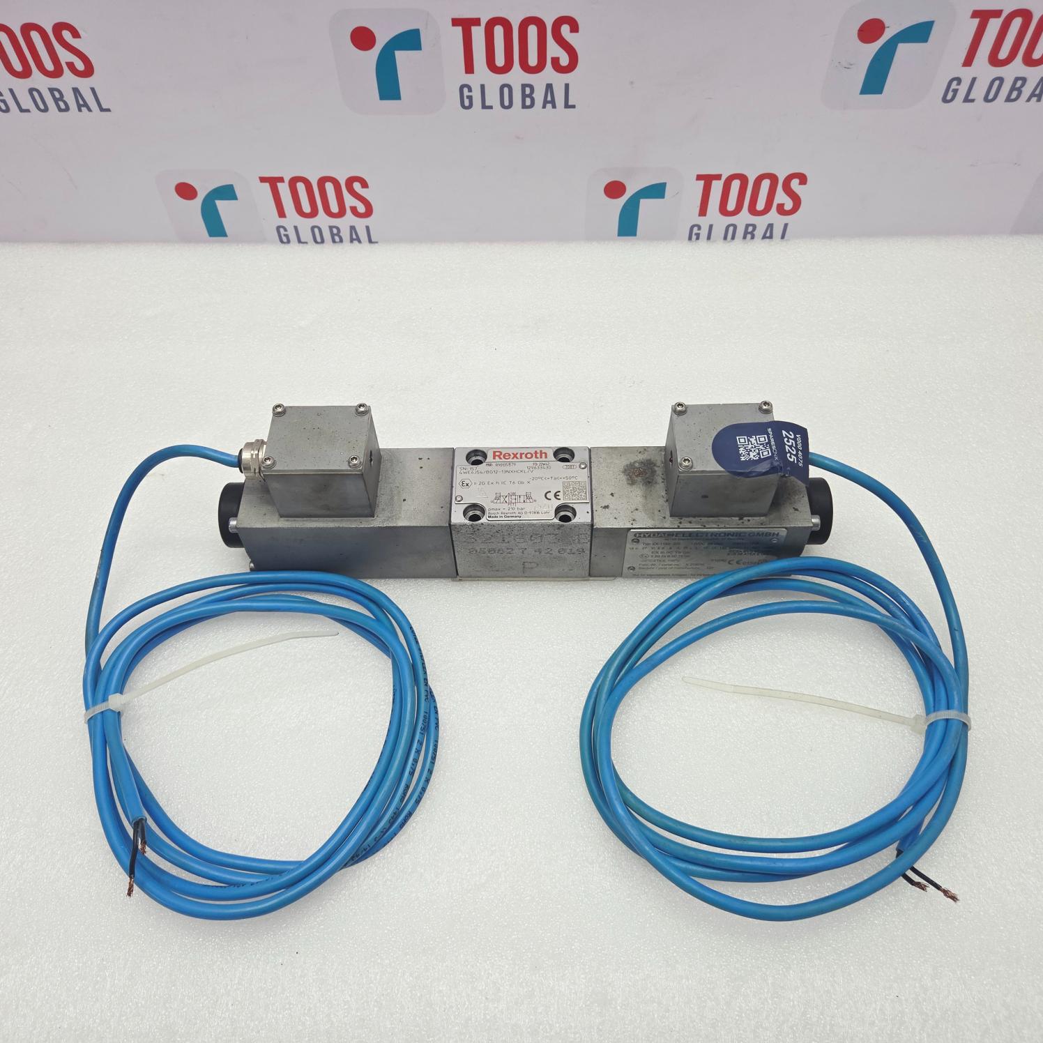 A Rexroth R901351579 4WE6J54/BG12-13NXHCKL/V Valve Hydac EX-1195-200 with two blue cable sensors, displayed on a white surface with a branded background.