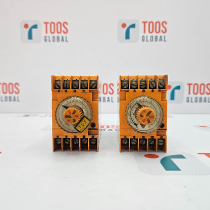 Two orange electronic devices with a clock face on a white background with 'TOOS GLOBAL' branding.