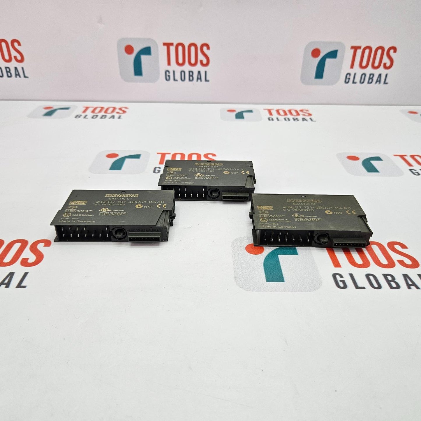 Electronic components on a TOOS GLOBAL branded background