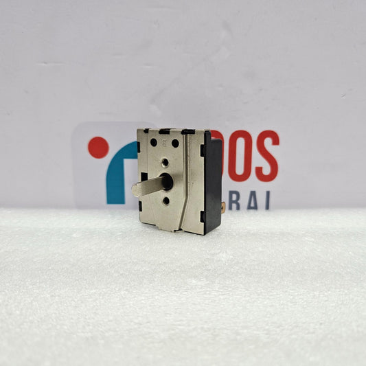 Mechanical component on a textured white surface with a blurred background featuring logos.
