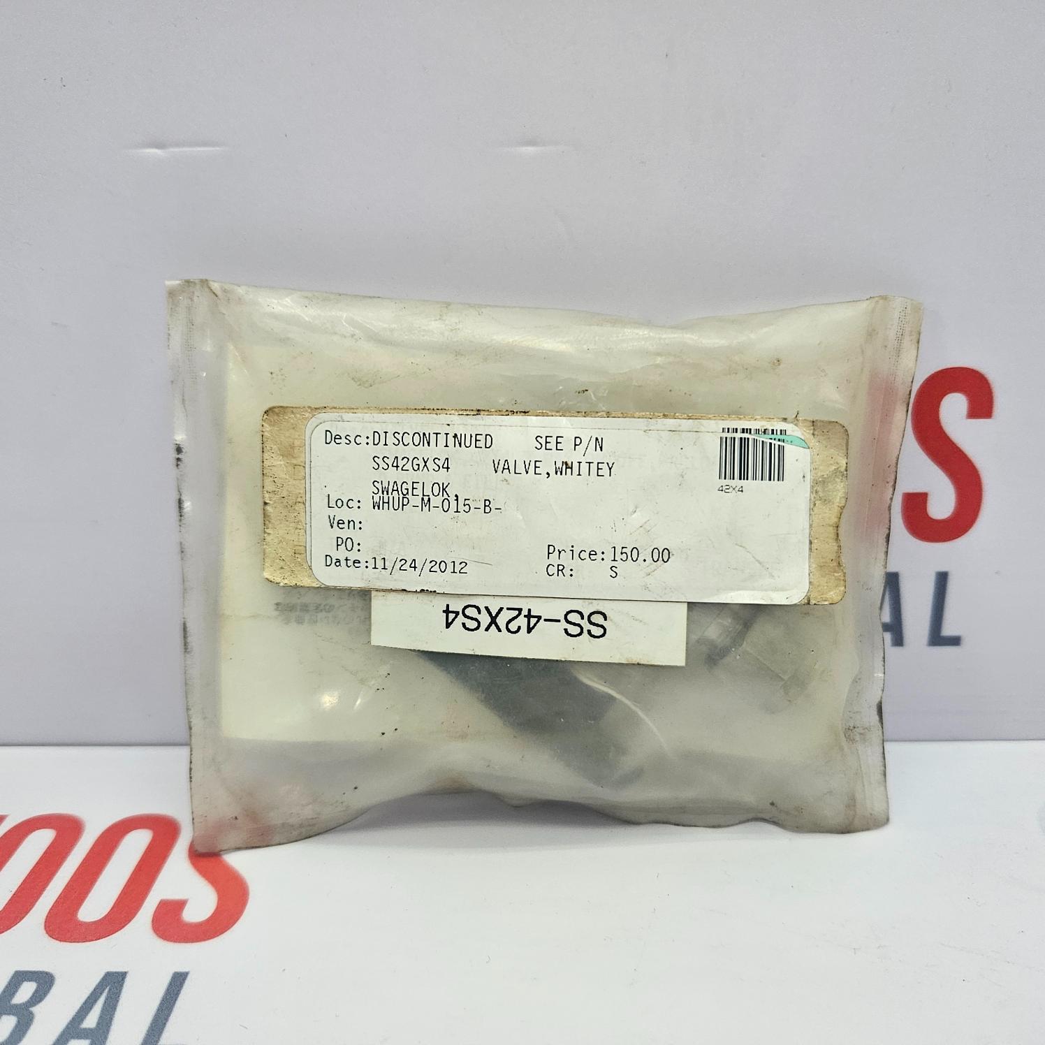 SWAGELOK SS-42GXS4 3 WAY BALL VALVE packaged in a plastic bag with a label showing the model number and other details, placed on a white surface.
