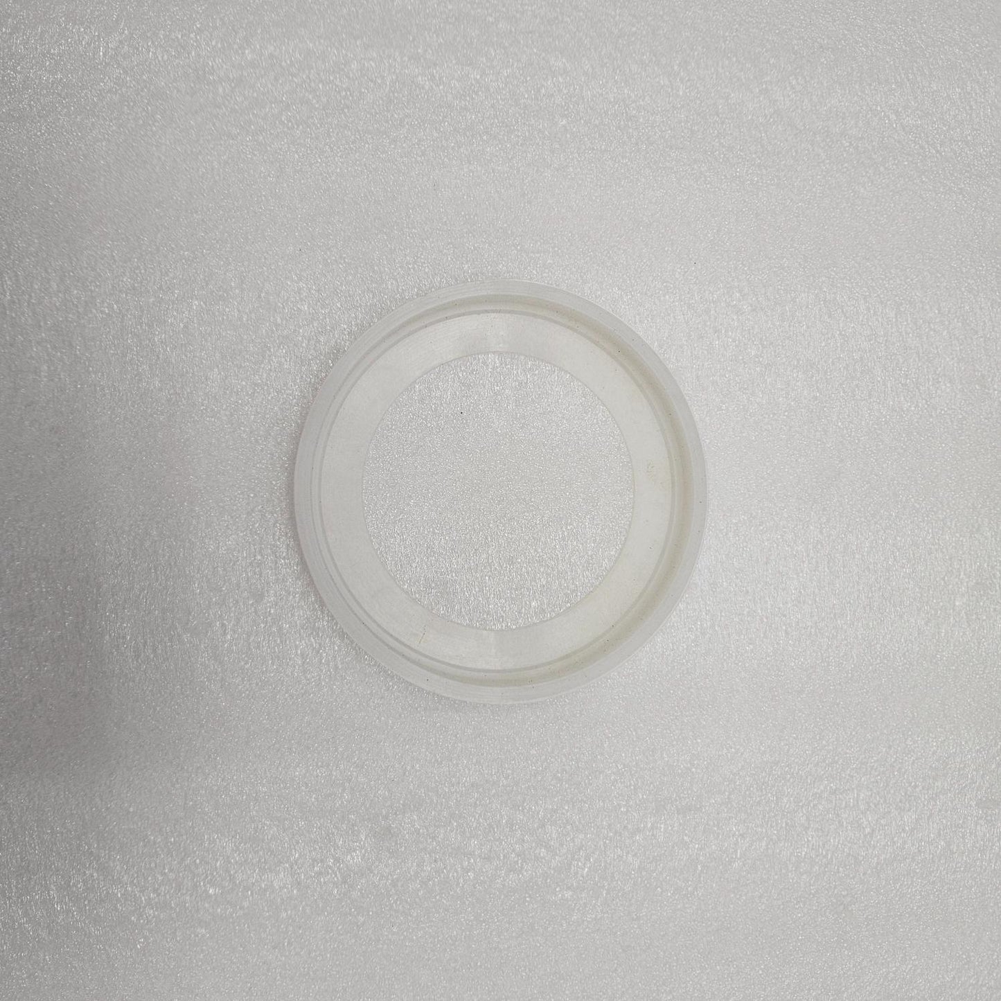 Clear plastic ring on a textured gray background