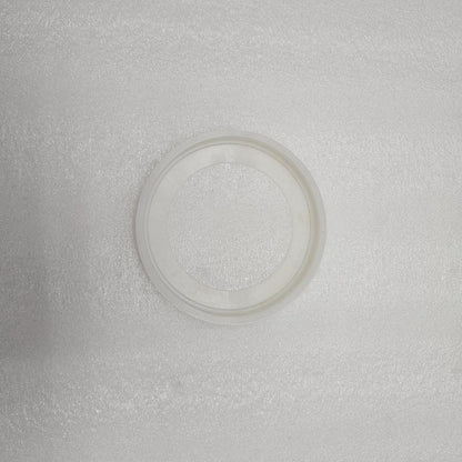 Clear plastic ring on a textured gray background