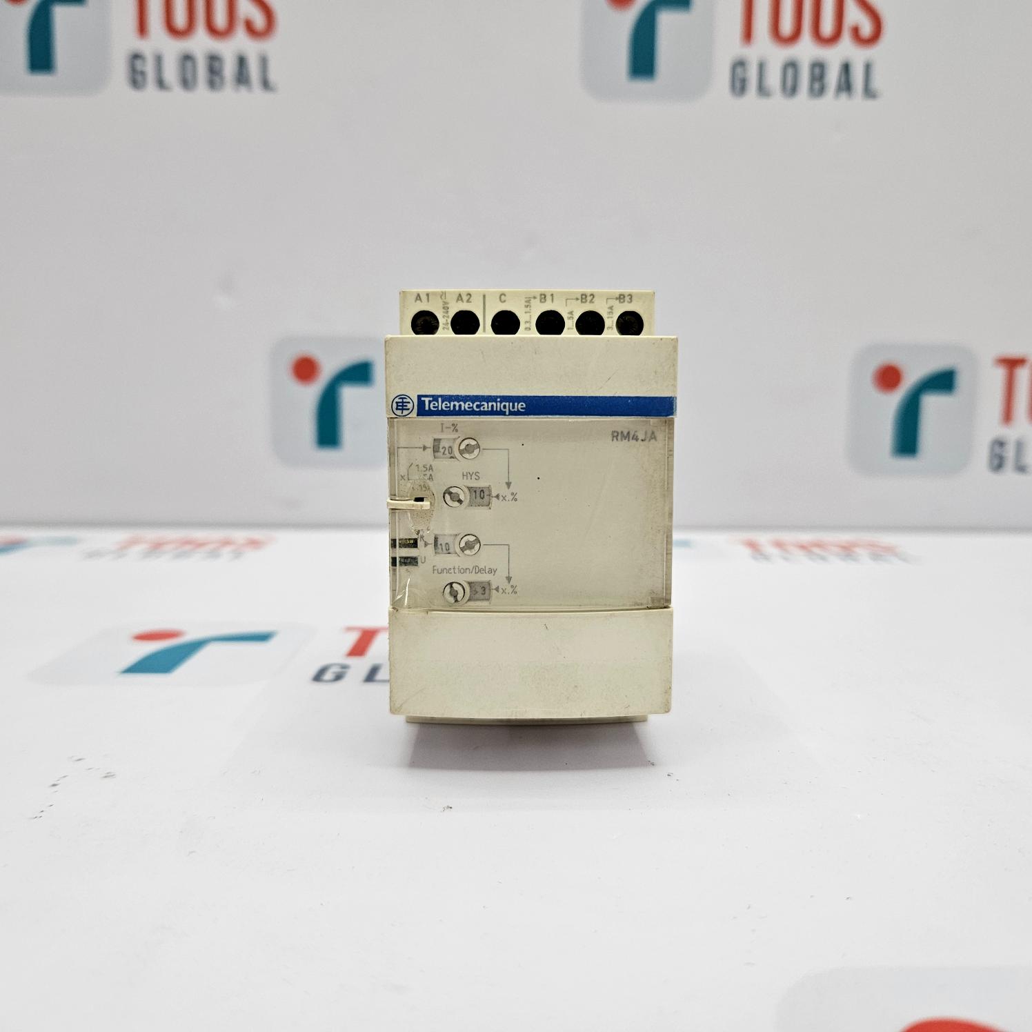 Control panel with Telemecanique branding on a white background with blurred logos.